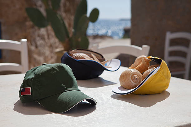 three baseball caps laying on table