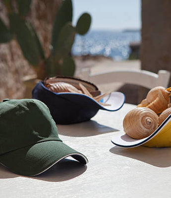 three baseball caps laying on table